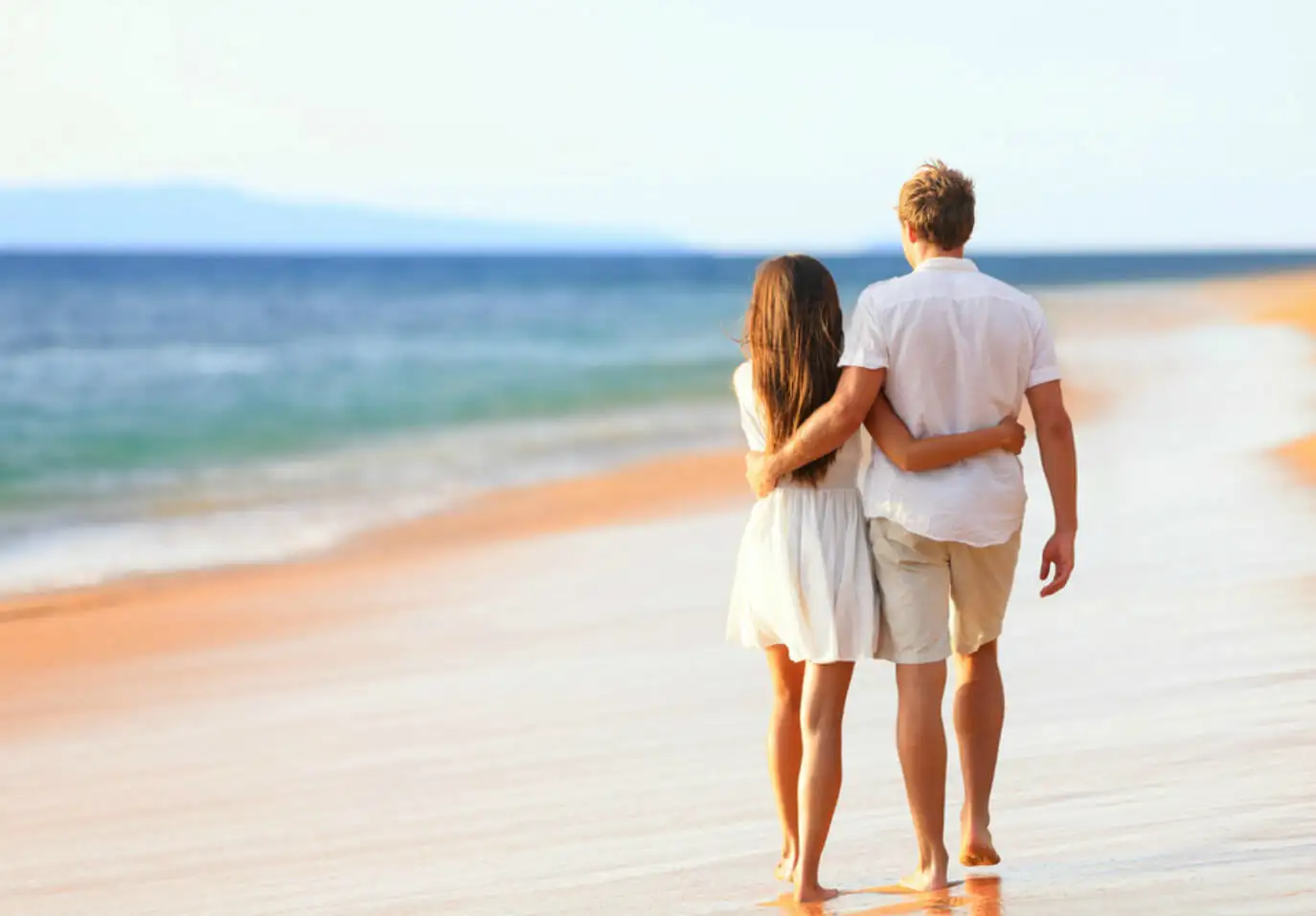 Honeymoon Tour 86 Couple taking romantic walk on the beach 1